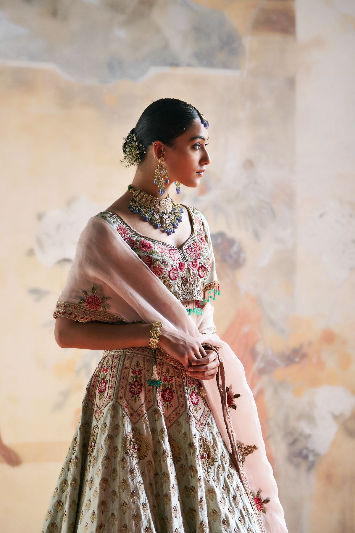 Green zardozi lehenga set.