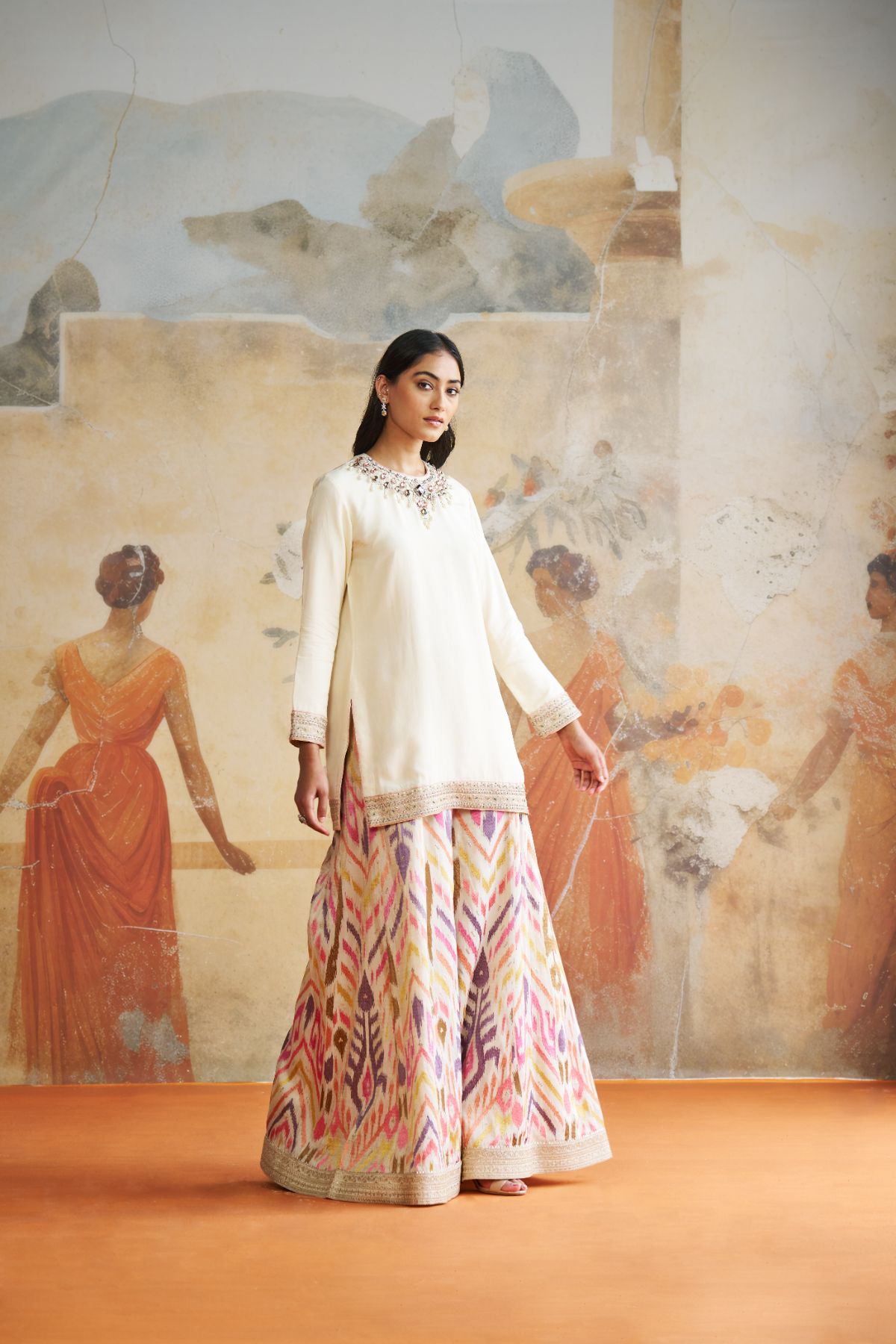 Jeweled short kurta set in peach stones.